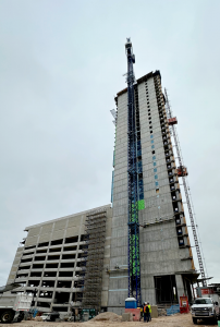 Ground level view of The Travis Building in Downtown Austin in mid-construction.