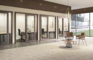A row of offices feature the SpecSlide Sliding Door System in a wood grain finish.